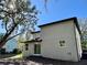 Two-story house with light taupe exterior, in a wooded area at 16417 Lake Byrd Dr, Tampa, FL 33618