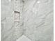 Spa-like shower with marble tile and pebble mosaic accents at 16417 Lake Byrd Dr, Tampa, FL 33618