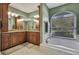 Elegant bathroom with double vanity, soaking tub, and window at 19505 Coachlight Way, Lutz, FL 33549