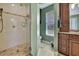 Bathroom with walk-in shower, toilet, and vanity at 19505 Coachlight Way, Lutz, FL 33549