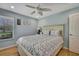 Bedroom with ceiling fan and wood flooring at 19505 Coachlight Way, Lutz, FL 33549