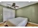 Bedroom with white closet doors and ceiling fan at 19505 Coachlight Way, Lutz, FL 33549