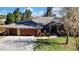 Two-car garage and brick house with landscaped yard at 19505 Coachlight Way, Lutz, FL 33549