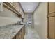 Laundry room with granite countertop and ample cabinets at 19505 Coachlight Way, Lutz, FL 33549
