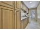 Laundry room with granite countertop and ample cabinets at 19505 Coachlight Way, Lutz, FL 33549