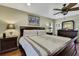 Main bedroom with king-size bed and hardwood floors at 19505 Coachlight Way, Lutz, FL 33549