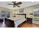 Spacious main bedroom with king-size bed and hardwood floors at 19505 Coachlight Way, Lutz, FL 33549