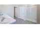 Bathroom with double sinks, marble countertops, and a walk-in shower at 32746 Osprey Peak Way, San Antonio, FL 33576