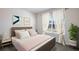 Cozy bedroom with a pink comforter and a large window at 32746 Osprey Peak Way, San Antonio, FL 33576