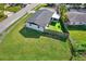 Aerial view showing house, fenced backyard, and spacious lawn at 4916 Carlyle Rd, Tampa, FL 33615
