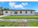 White single-story home with a newly landscaped lawn at 4916 Carlyle Rd, Tampa, FL 33615