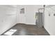 Bright laundry room with washer and dryer hookups, built-in shelving and vinyl flooring at 4916 Carlyle Rd, Tampa, FL 33615