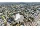 Aerial view of home near lake, showcasing surrounding houses and landscape at 5269 61St N Way, Kenneth City, FL 33709