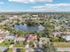 Aerial view of a house near a lake, showcasing the property and surrounding neighborhood at 5269 61St N Way, Kenneth City, FL 33709