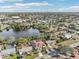 Aerial view of a house near a lake, showcasing the property and surrounding neighborhood at 5269 61St N Way, Kenneth City, FL 33709