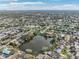 Aerial view of a lakefront community, showcasing the surrounding houses and landscape at 5269 61St N Way, Kenneth City, FL 33709