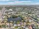 Aerial view showcasing a house's location near a lake and the surrounding neighborhood at 5269 61St N Way, Kenneth City, FL 33709