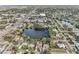 Aerial view showcasing a house's location near a lake and the surrounding neighborhood at 5269 61St N Way, Kenneth City, FL 33709