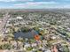 Aerial view showcasing a house's location near a lake and the surrounding neighborhood at 5269 61St N Way, Kenneth City, FL 33709