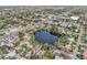 Aerial view showcasing a house's location near a lake and the surrounding neighborhood at 5269 61St N Way, Kenneth City, FL 33709