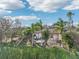 Backyard view, featuring a house surrounded by palm trees at 5269 61St N Way, Kenneth City, FL 33709