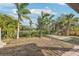 Backyard with lake access and lush tropical landscaping at 5269 61St N Way, Kenneth City, FL 33709