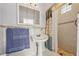 Bathroom with pedestal sink, shower, and blue towel at 5269 61St N Way, Kenneth City, FL 33709