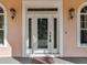 White front door with etched glass and sidelights, enhancing curb appeal at 5269 61St N Way, Kenneth City, FL 33709