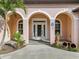 Elegant front entry with arched detail, white door, and decorative glass at 5269 61St N Way, Kenneth City, FL 33709