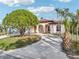Stunning curb appeal with circular driveway and lush landscaping at 5269 61St N Way, Kenneth City, FL 33709