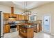 Large kitchen with island, wood cabinets, and granite countertops at 5269 61St N Way, Kenneth City, FL 33709