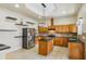 Bright kitchen with island, wood cabinets, granite countertops, and stainless steel appliances at 5269 61St N Way, Kenneth City, FL 33709