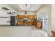 L-shaped kitchen with island, wood cabinets, granite counters, and stainless steel appliances at 5269 61St N Way, Kenneth City, FL 33709