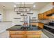 Island kitchen with granite countertops, stainless steel appliances, and wood cabinets at 5269 61St N Way, Kenneth City, FL 33709