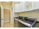 Laundry room with LG washer and dryer and white cabinets at 5269 61St N Way, Kenneth City, FL 33709