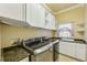 Laundry room with LG washer and dryer, white cabinets, and granite countertop at 5269 61St N Way, Kenneth City, FL 33709