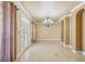 Spacious living room with high ceilings, tile floors, and elegant chandelier at 5269 61St N Way, Kenneth City, FL 33709