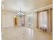 Spacious living room with high ceilings, tile floors, and elegant chandelier at 5269 61St N Way, Kenneth City, FL 33709