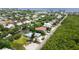 Aerial view of canal-front home with lush landscaping and nearby beach at 616 Lyons Ln, Longboat Key, FL 34228