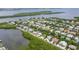Wide aerial showcasing waterfront homes and lush tropical landscape at 616 Lyons Ln, Longboat Key, FL 34228