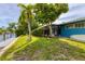 Landscaped backyard with canal access, and tropical foliage at 616 Lyons Ln, Longboat Key, FL 34228