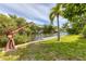 Private dock with lift and lush lawn space on the canal at 616 Lyons Ln, Longboat Key, FL 34228