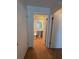 Bathroom featuring a commode and pedestal sink; entrance visible from hall at 6177 Chesham Dr # 6, New Port Richey, FL 34653