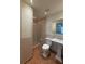 The bathroom has a shower, commode, and vanity with ample lighting and neutral colors at 6177 Chesham Dr # 6, New Port Richey, FL 34653