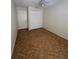 Clean bedroom with neutral walls, closet storage, and matching floors at 6177 Chesham Dr # 6, New Port Richey, FL 34653