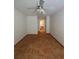 Spacious bedroom with tile flooring, a ceiling fan, a window, and an ensuite bathroom at 6177 Chesham Dr # 6, New Port Richey, FL 34653