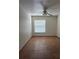 This bedroom features a neutral color scheme, tile flooring, a ceiling fan, and a window at 6177 Chesham Dr # 6, New Port Richey, FL 34653