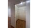 Open closet with shelving, adjacent to a bedroom with tile floors at 6177 Chesham Dr # 6, New Port Richey, FL 34653