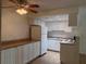 Functional kitchen with white cabinetry, matching appliances, and laminate countertops at 6177 Chesham Dr # 6, New Port Richey, FL 34653