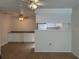 Open kitchenette with white cabinetry and laminate countertops, seamlessly connected to the living space at 6177 Chesham Dr # 6, New Port Richey, FL 34653